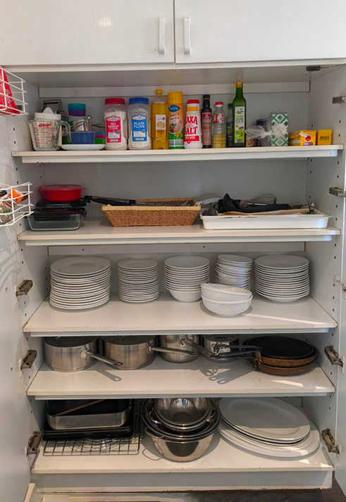 Pantry view with condiments and plates